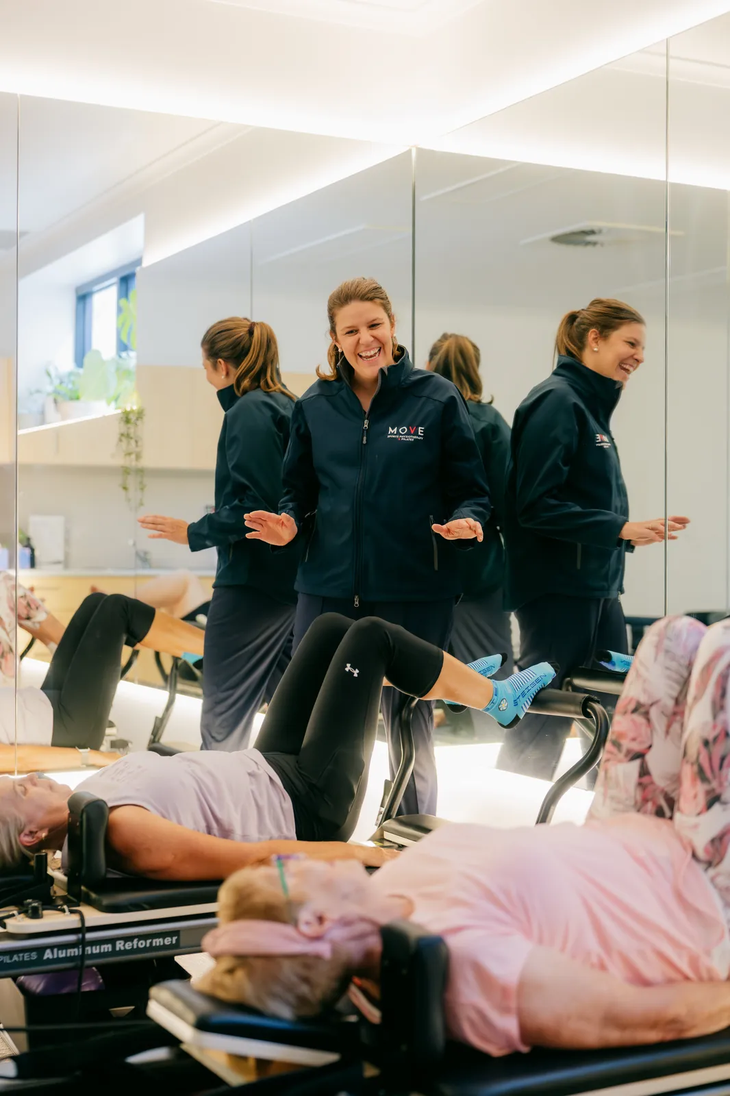 Jess McDonald, physiotherapist and founder of The Clinical Collective, smiling while teaching clinical Pilates in the studio